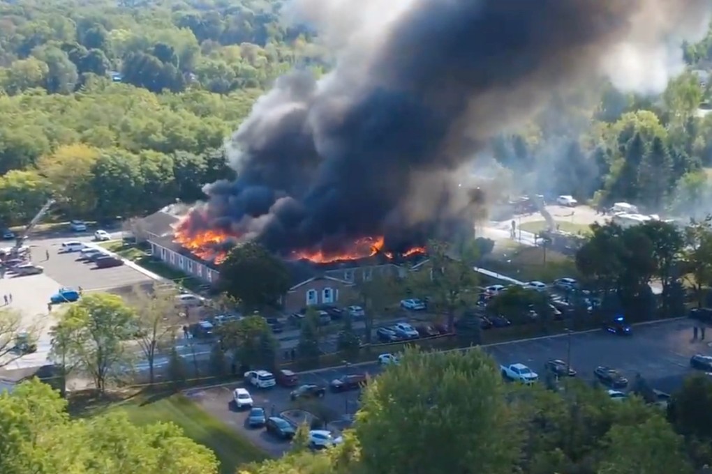 Flames and smoke rise from The Church of Jesus Christ of Latter-day Saints in Grand Blanc, Michigan on Sunday after a shooting. Photo: Julie J, @Malkowski6April via AP