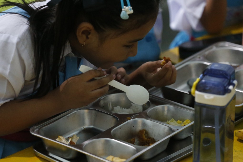 Indonesian students eat a free meal at a school in Keutapang, Indonesia, on Monday. Photo: EPA