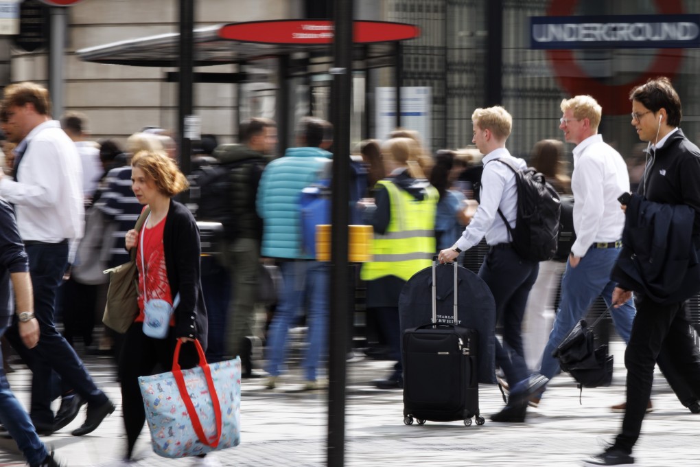 London commuters walk outside Victoria station during rush hour. Photo: EPA