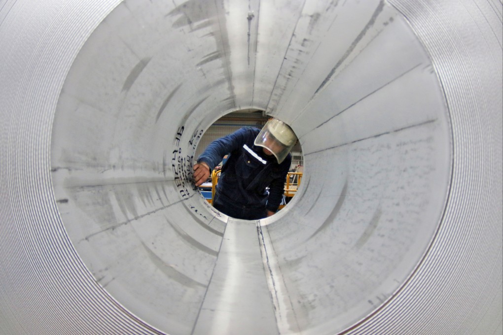 An employee works at the production line of aluminium rolls at a factory in Zouping, Shandong province, in November 2019. Photo: Reuters