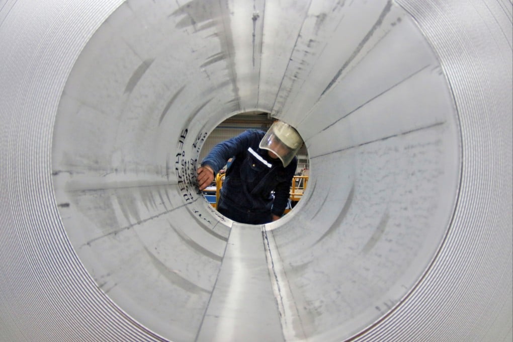 An employee works at the production line of aluminium rolls at a factory in Zouping, Shandong province, in November 2019. Photo: Reuters