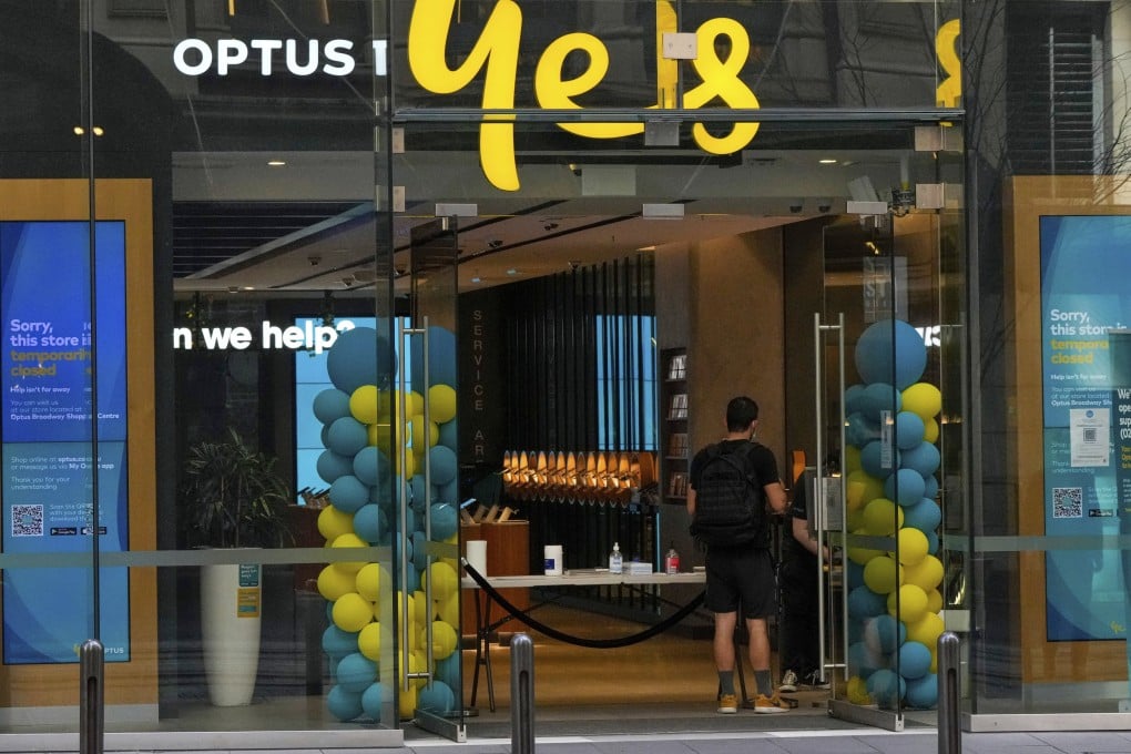 A customer waits for service at an Optus store in Sydney, Australia. Photo: AP