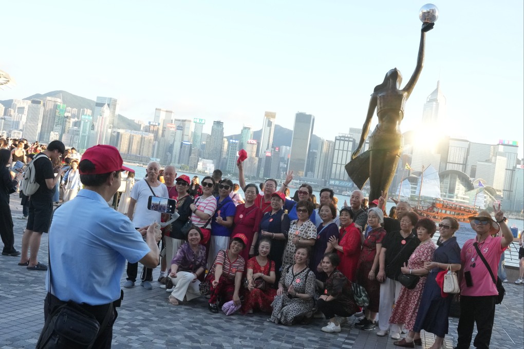 Tourists gather for a photo along the Tsim Sha Tsui waterfront on September 26, ahead of the National Day holiday. Photo: May Tse