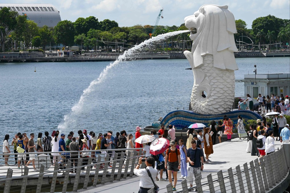 People visit the iconic Merlion statue on the Marina Bay waterfront in Singapore. Photo: AFP