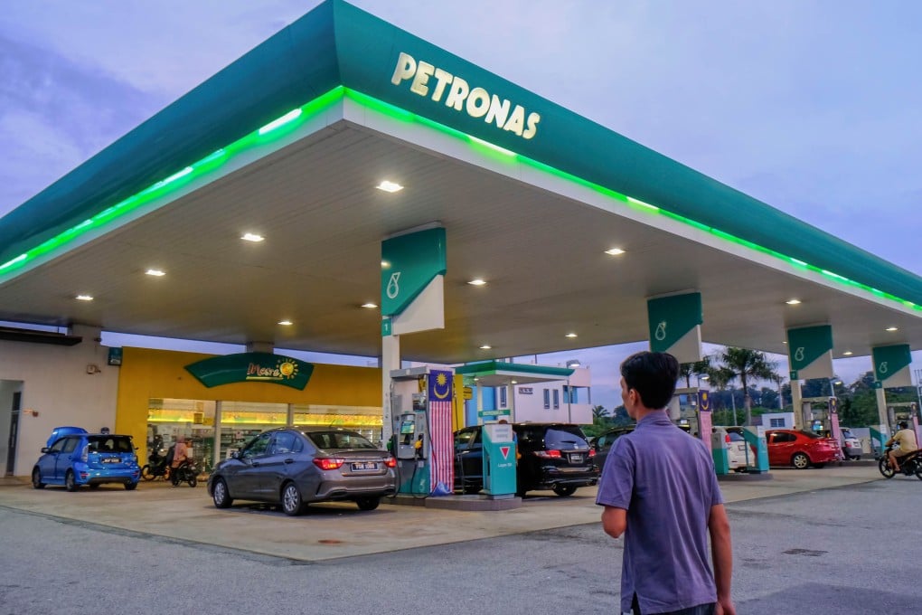A man enters a Petronas petrol station in Kuala Lumpur. Malaysia has launched a new targeted fuel subsidy scheme limiting discounted purchases to 300 litres a month. Photo: Getty Images