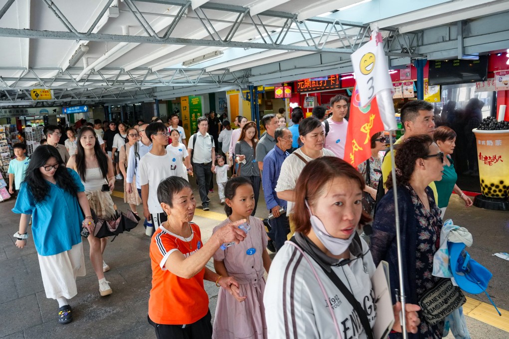 Tourists head towards the Victoria Harbour waterfront in Tsim Sha Tsui. Photo: May Tse