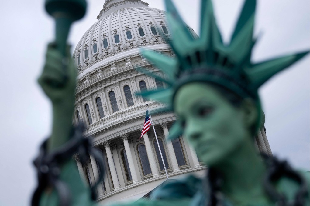 A protester dressed as the Statue of Liberty stands in front of the US Capitol in Washington on Monday as the US government faces a shutdown. Photo: AFP