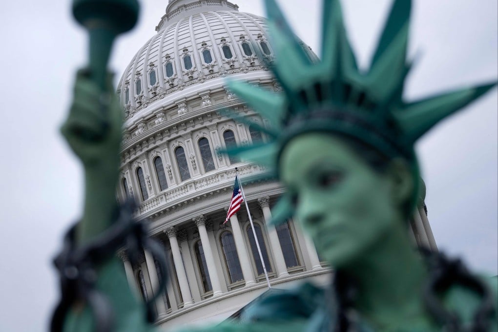 A protester dressed as the Statue of Liberty stands in front of the US Capitol in Washington on Monday as the US government faces a shutdown. Photo: AFP