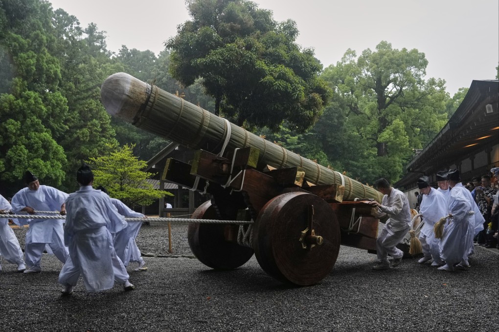 Shinto officials in the priesthood pull a sacred timber on a wheeled platform into a position before unloading and moving it under a roof during the rebuilding of the Ise Jingu shrine complex, in Ise, Japan, in June 2025. The shrine is rebuilt every 20 years. Photo: AP