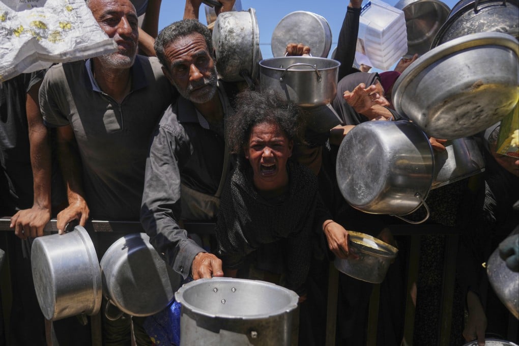 Palestinians struggle to get donated food in the Gaza Strip’s Khan Younis. Photo: AP