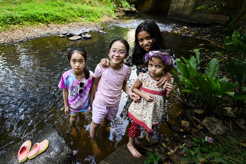 (From left) Hong Kong psychiatrist Dr Ivan Mak’s two daughters pose with their new Sri Lankan friends on a family trip to the country. Mak says he and his family learned valuable lessons about mental well-being and making connections on the trip. Photo: courtesy of Ivan Mak