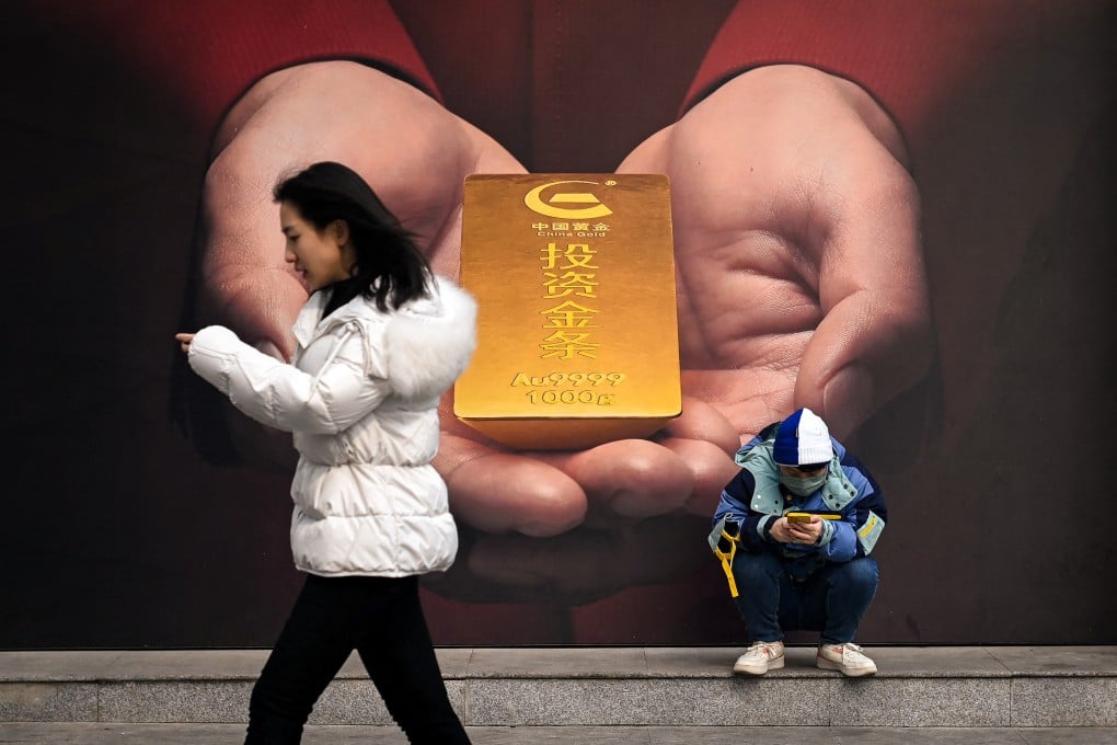 A poster showing a gold bar is pictured on a street in Beijing on February 27, 2024. Photo: AFP