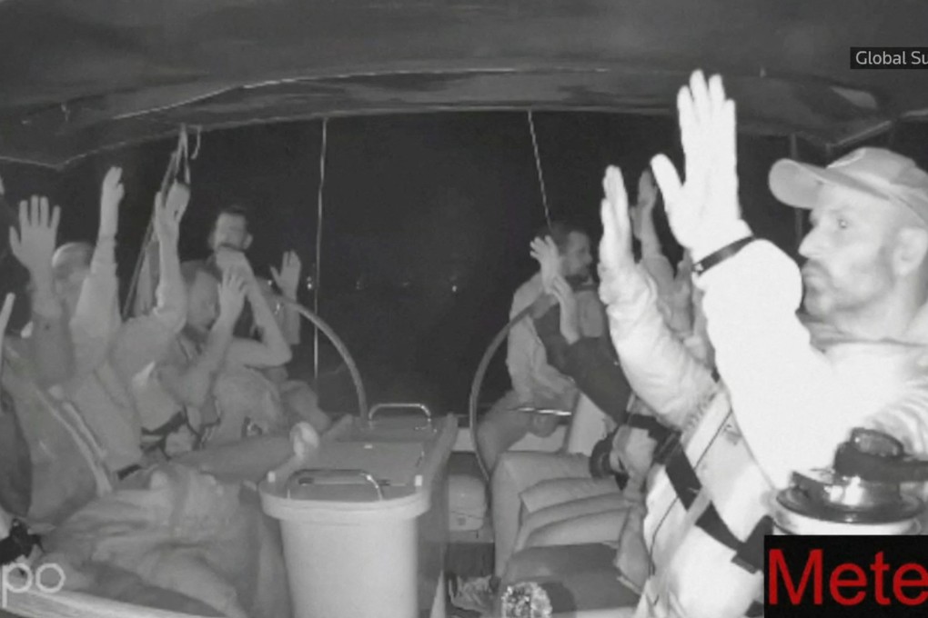 The crew of a Gaza-bound vessel put their hands up as they are intercepted by Israeli security forces. Photo: Global Sumud Flotilla via Reuters