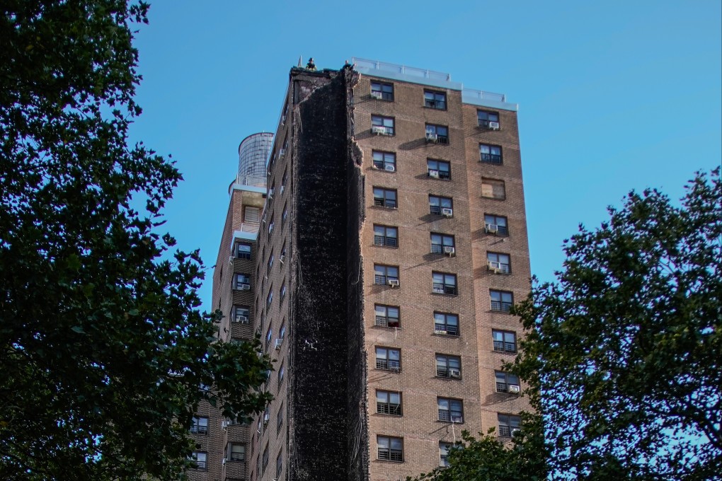Firefighters on the roof of the building that partially collapsed. Photo: AP