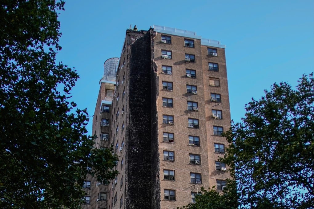 Firefighters on the roof of the building that partially collapsed. Photo: AP