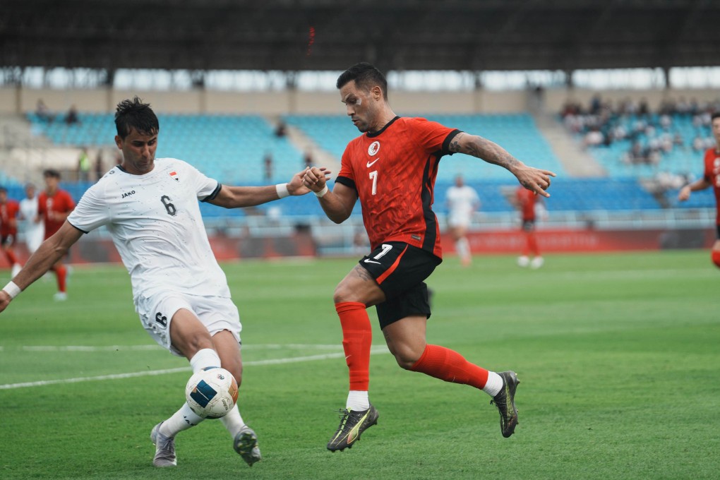 Juninho (right) applies pressure on defender Manaf Younis during Hong Kong’s defeat by Iraq last month. Photo: HKFA