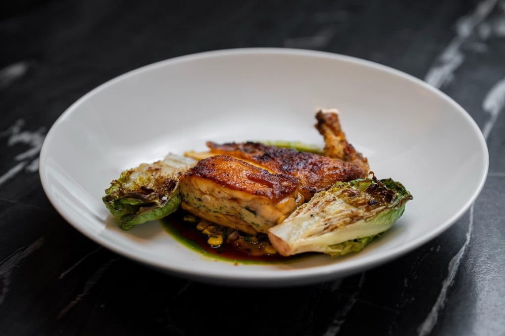 Roasted half yellow chicken with corn fricassee and baby gem lettuce. Photo: Clarence