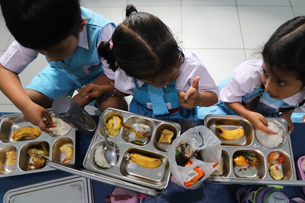 Indonesian students eat a free meal at a school in Keutapang, Aceh Besar, Indonesia, on Monday. Photo: EPA