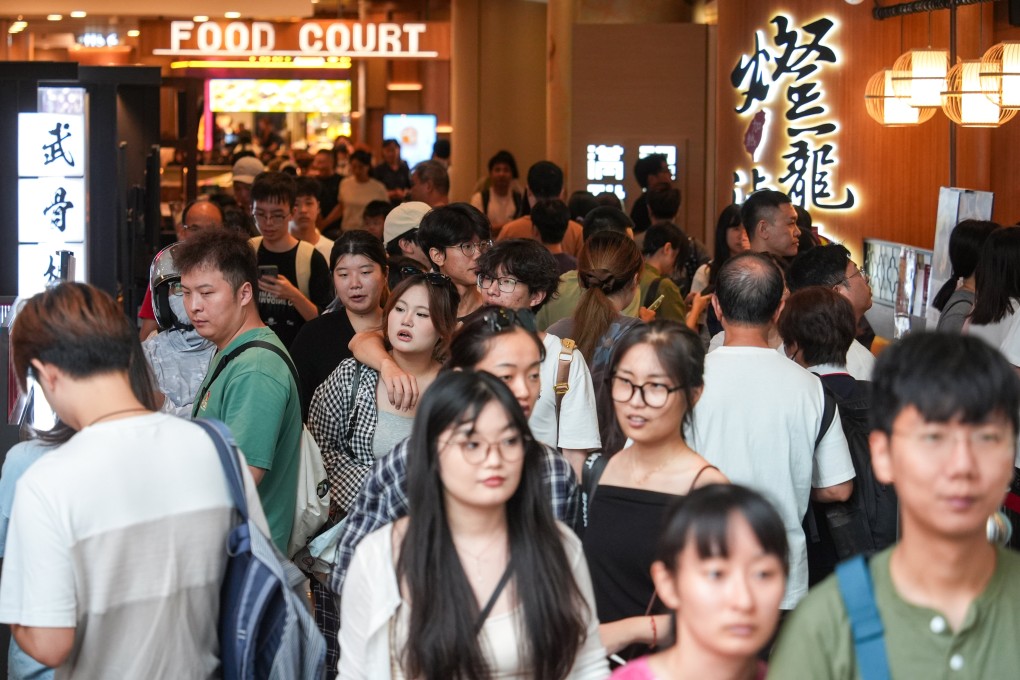 Tourists and residents flock to a shopping centre in Mong Kok. Photo: Eugene Lee