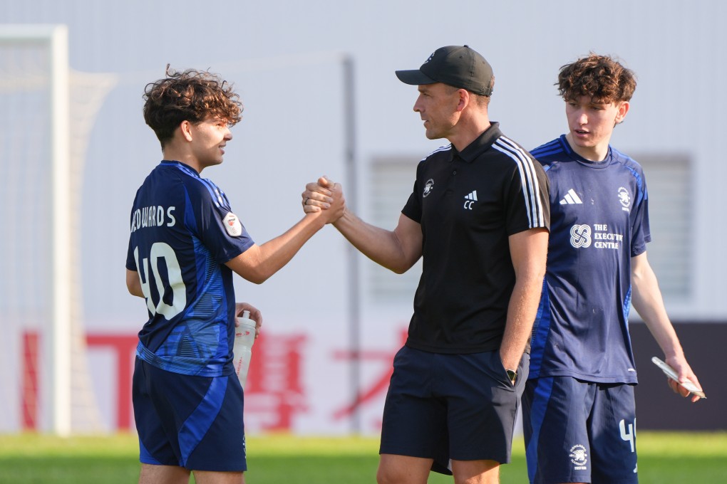 Chancy Cooke, here with teenage midfielder Nicholas Kedwards, is aiming to rediscover the winning formula for Football Club. Photo: Eugene Lee