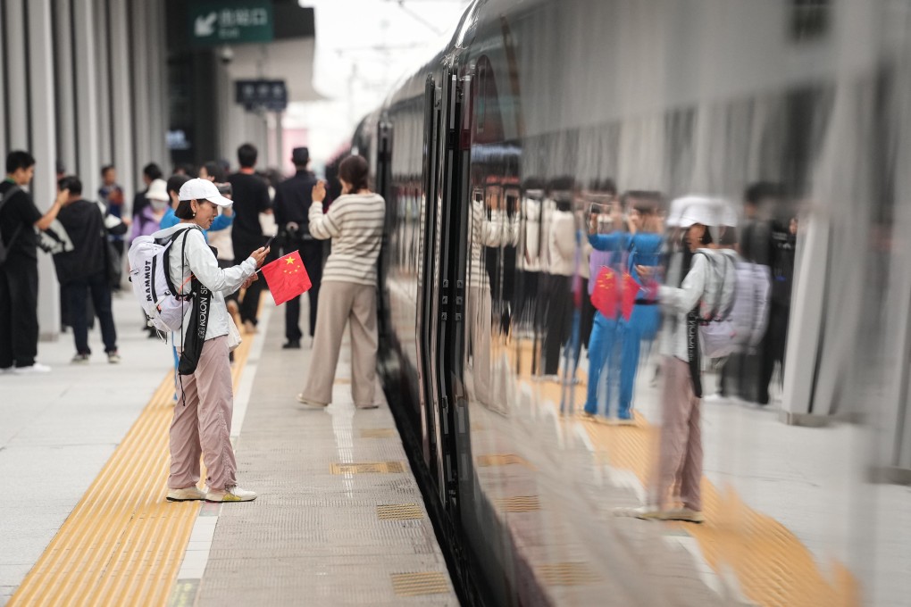 A passenger preparing to board a train in Fushun, Liaoning province on September 28, when the Shenyang-Baihe section of the Shenyang-Jiamusi high-speed railway opened. Photo: Xinhua