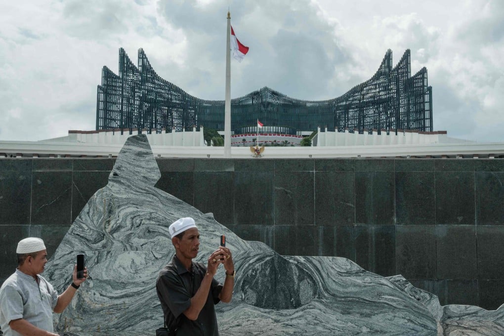 People take photos in front of the presidential palace in Nusantara, East Kalimantan, in August. Photo: AFP