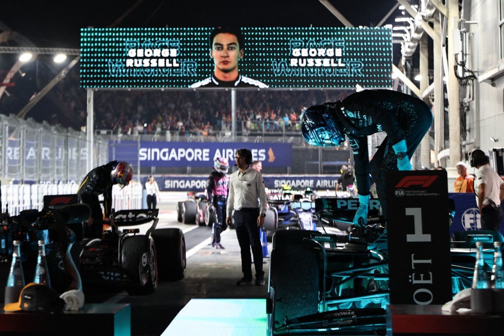 Mercedes’ George Russell climbs out of his car after winning the Singapore Grand Prix. Photo: Reuters