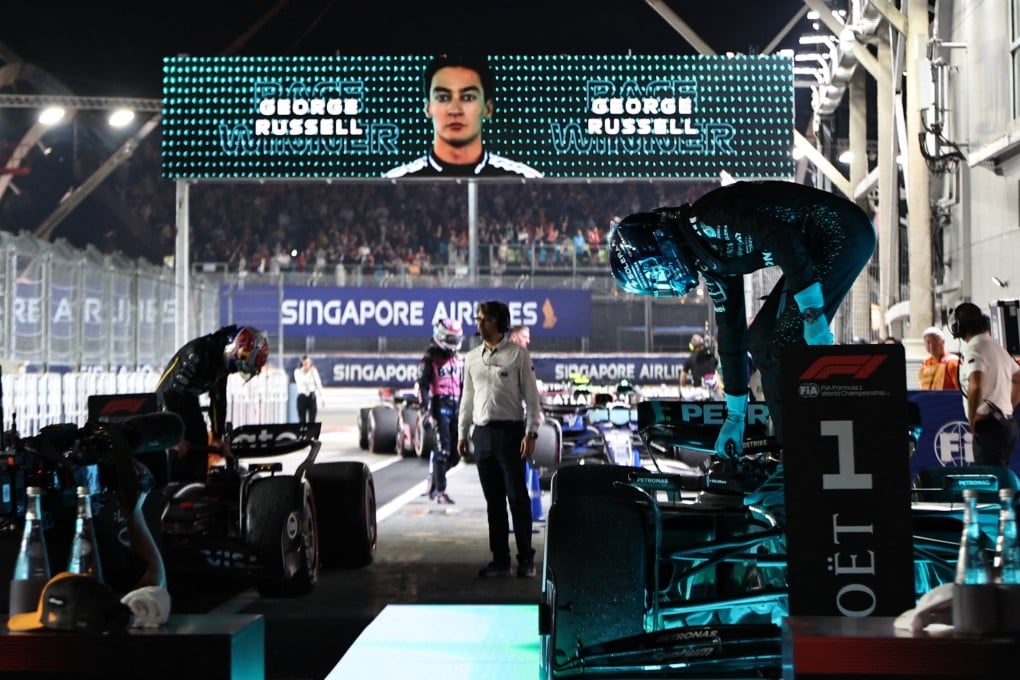 Mercedes’ George Russell climbs out of his car after winning the Singapore Grand Prix. Photo: Reuters