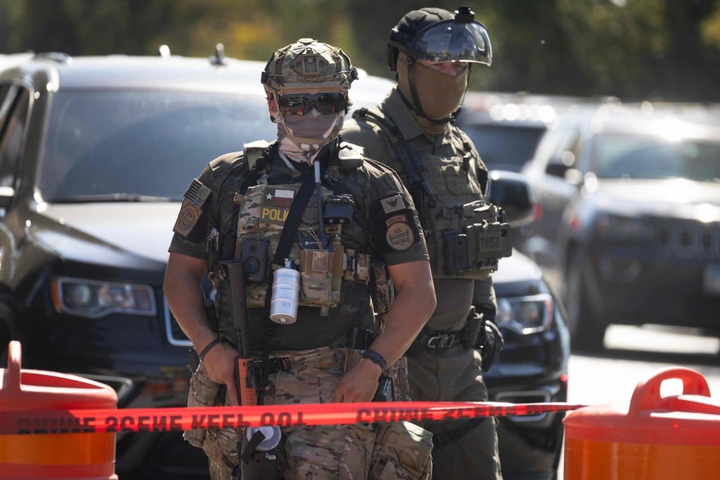 Federal law enforcement agents stand guard as they are confronted by community members and activists for reportedly shooting a woman in Broadview, Illinois, on Saturday. Photo: AFP
