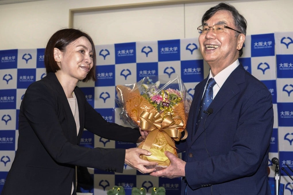 Osaka University professor Dr. Shimon Sakaguchi (right) receives flowers at a news conference near Osaka, Japan on Monday after he won the Nobel Prize in medicine. Photo: Kyodo/AP