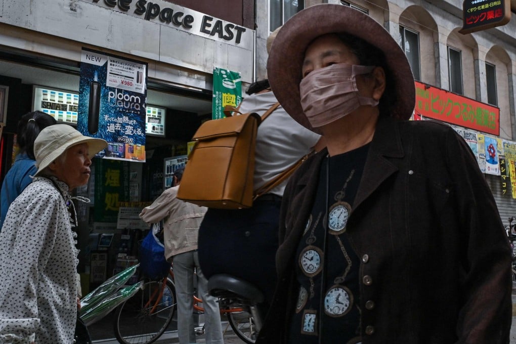 Elderly shoppers, some wearing face masks, walk through a shopping street in Osaka, Japan, earlier this month. Photo: AFP