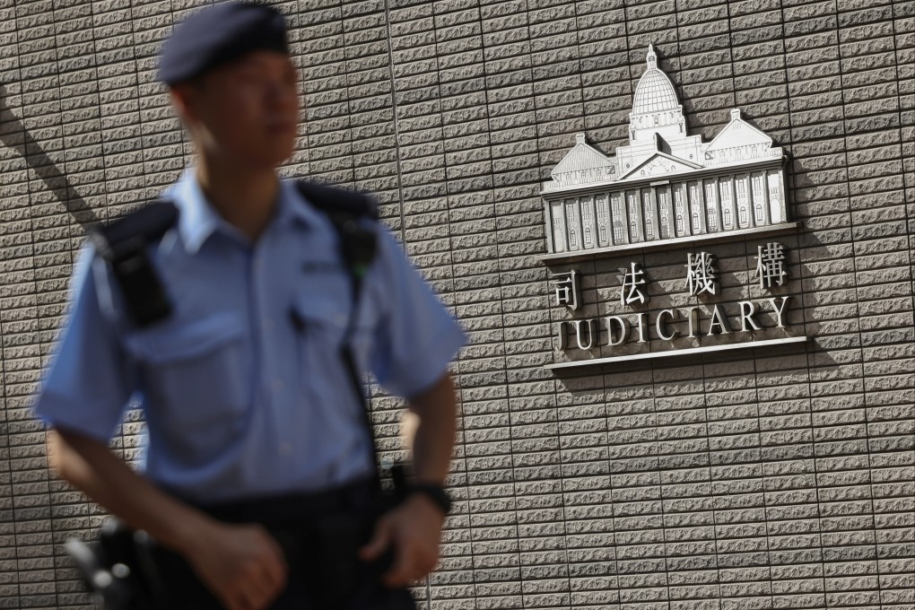 A police officer outside the West Kowloon Magistrates Court on September 29. Photo: Karma Lo