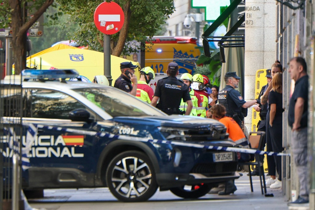 Police and emergency service workers are seen near the site of a collapsed building, which was being refurbished in Madrid on Tuesday. Photo: AFP