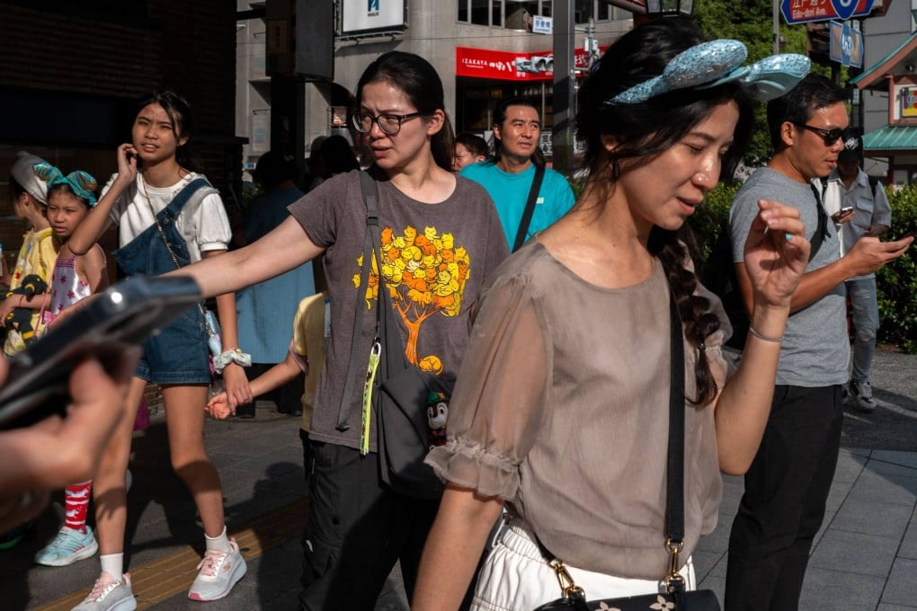 Tourists explore Asakusa district in Tokyo on Thursday. Photo: AFP