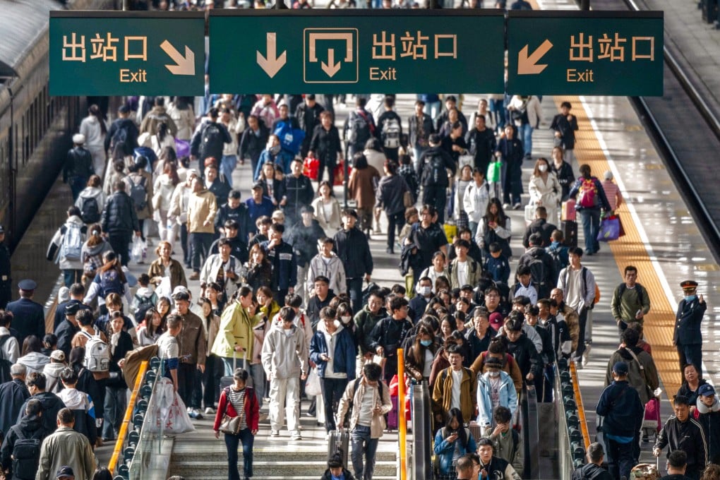 Passengers exit Harbin Railway Station on Tuesday. Authorities said the total number of trips during China’s eight-day holiday was expected to reach a record high of more than 2.4 billion. Photo: Xinhua