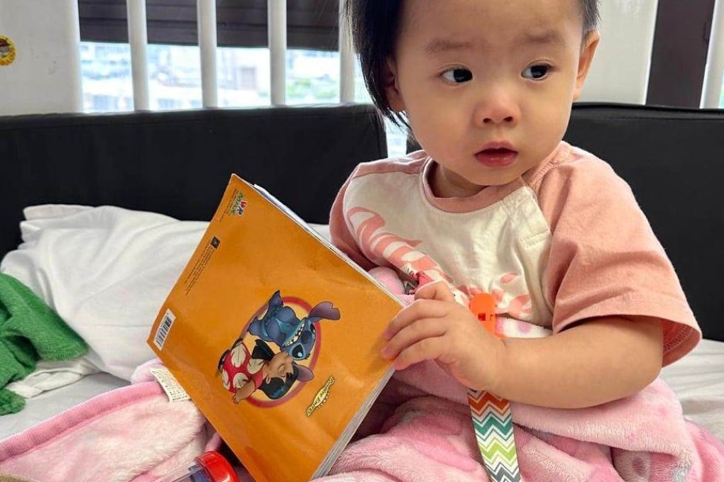 Suet-yee, who previously could not raise her right hand, can now move her fingers slightly and hold a dummy, her mum says. Photo: Family of Little Suet-yee