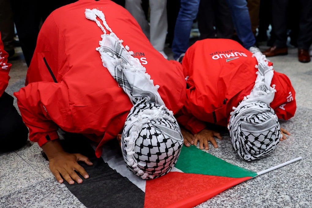 Malaysians from the Global Sumud Flotilla prostrate in prayer upon arriving at Kuala Lumpur International Airport on Tuesday. Photo: EPA