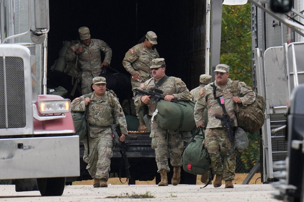 US military personnel in uniform, with the Texas National Guard patch on, are seen in Elwood, Illinois, a Chicago suburb, on Tuesday. Photo: AP