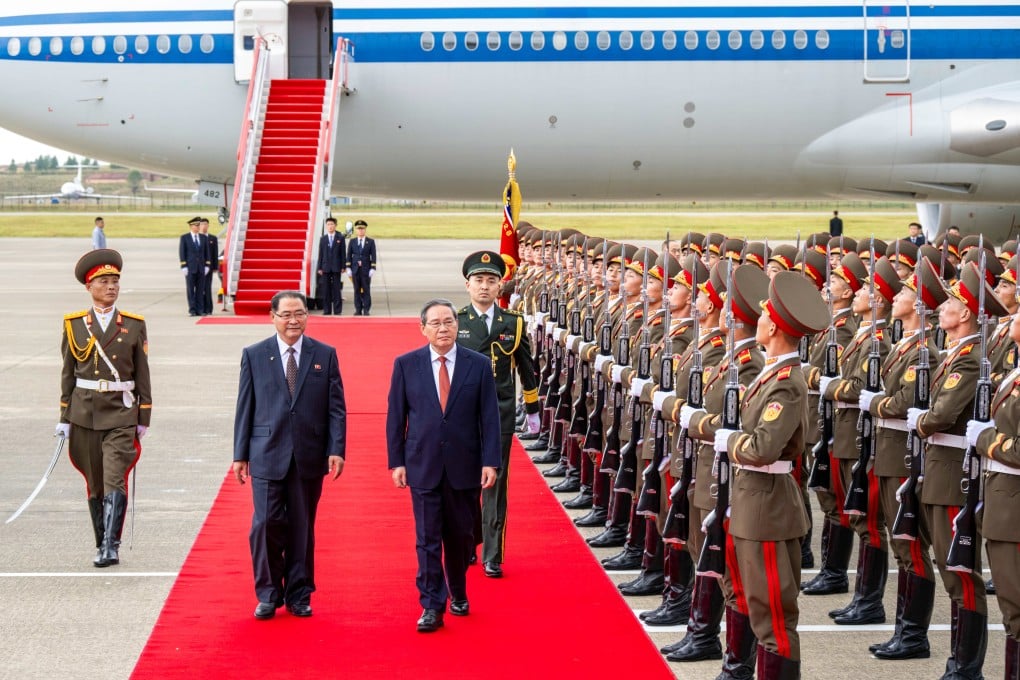 Li Qiang and Pak Thae-sung review a guard of honour in Pyongyang. Photo: Xinhua