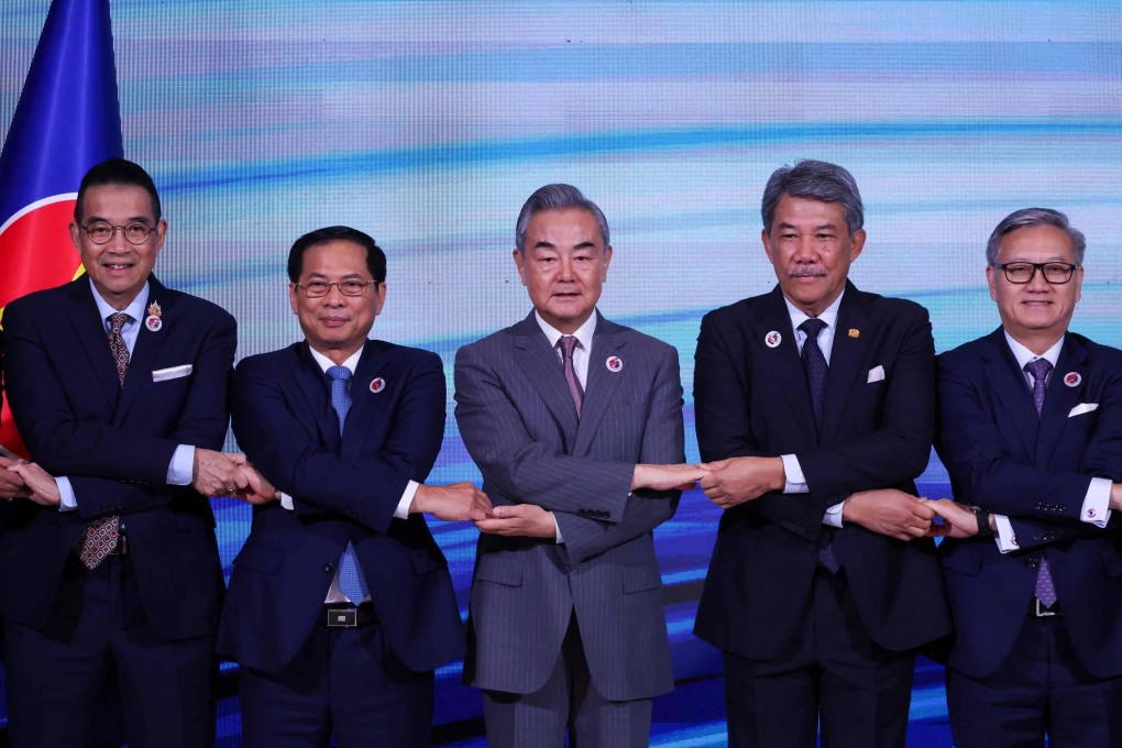 Thailand’s Minister of Foreign Affairs Maris Sangiampongsa, Vietnam’s Minister of Foreign Affairs Bui Thanh Son, China’s Foreign Minister Wang Yi, Malaysia’s Minister of Foreign Affairs Mohamad Hasan and Laos’ Minister of Foreign Affairs Thongsavanh Phomvihane join hands for a group photo as they attend the Association of Southeast Asian Nations (Asean) Post-Ministerial Conference with China during the 58th Asean Foreign Ministers meeting in Kuala Lumpur on July 10. Photo: AFP