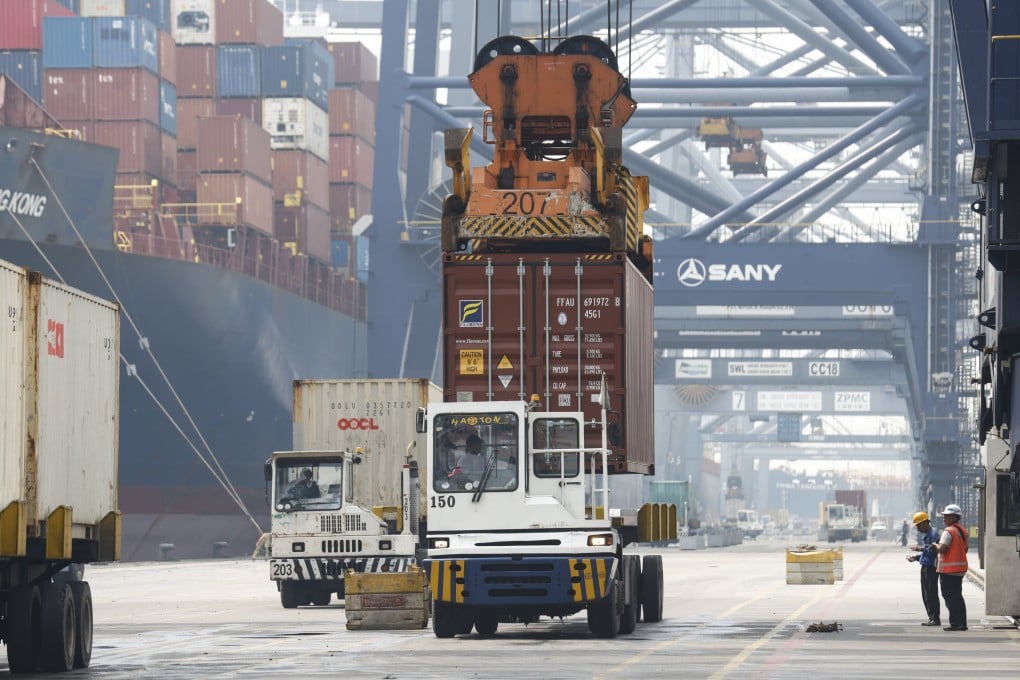 Containers are loaded onto transport trucks at a port in Jakarta, Indonesia in July. Photo: EPA