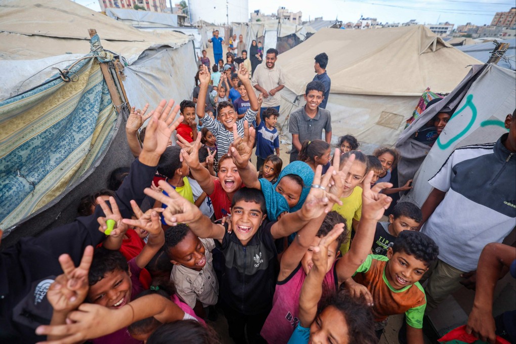 Palestinian children celebrate at a refugee camp in Nuseirat, in the central Gaza Strip, on October 9. Photo: AFP