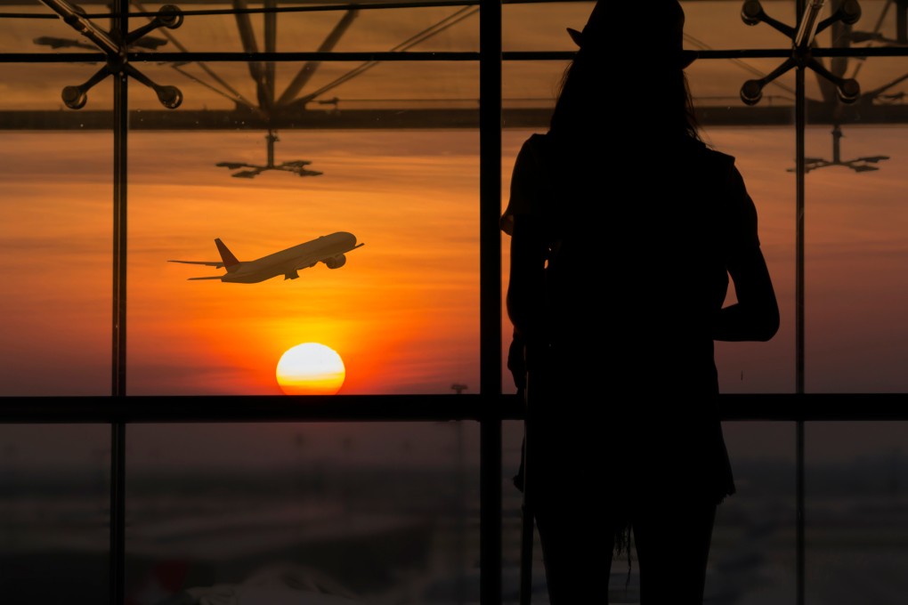 A woman watches plane take off at the airport. Photo: Shutterstock