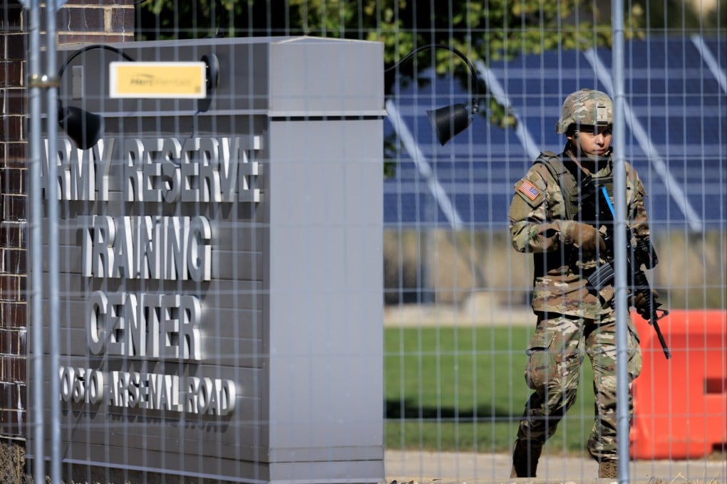 A service member in National Guard uniform patrols at the US Army Reserve Centre in Elwood, Illinois, on Thursday. Photo: EPA