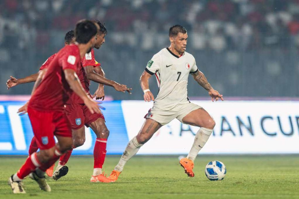 Juninho tries to evade a trio of Bangladesh defenders on a fevered night at Dhaka’s National Stadium. Photo: HKFA