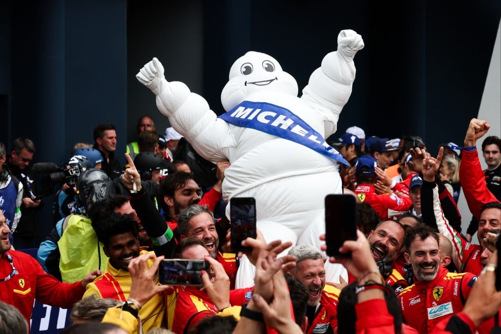The Michelin man celebrates at the 24 Hours of Le Mans race in France in 2024. Michelin has gone from a tyre maker to a fine-dining authority; will it succeed in the travel sector? Photo: James Moy Photography/Getty Images