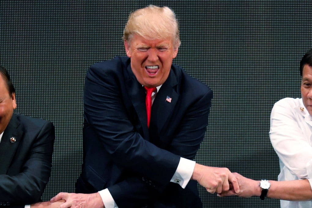 US President Donald Trump attempts the Asean handshake in 2017, the only previous occasion he attended one of the bloc’s summits. Photo: Reuters