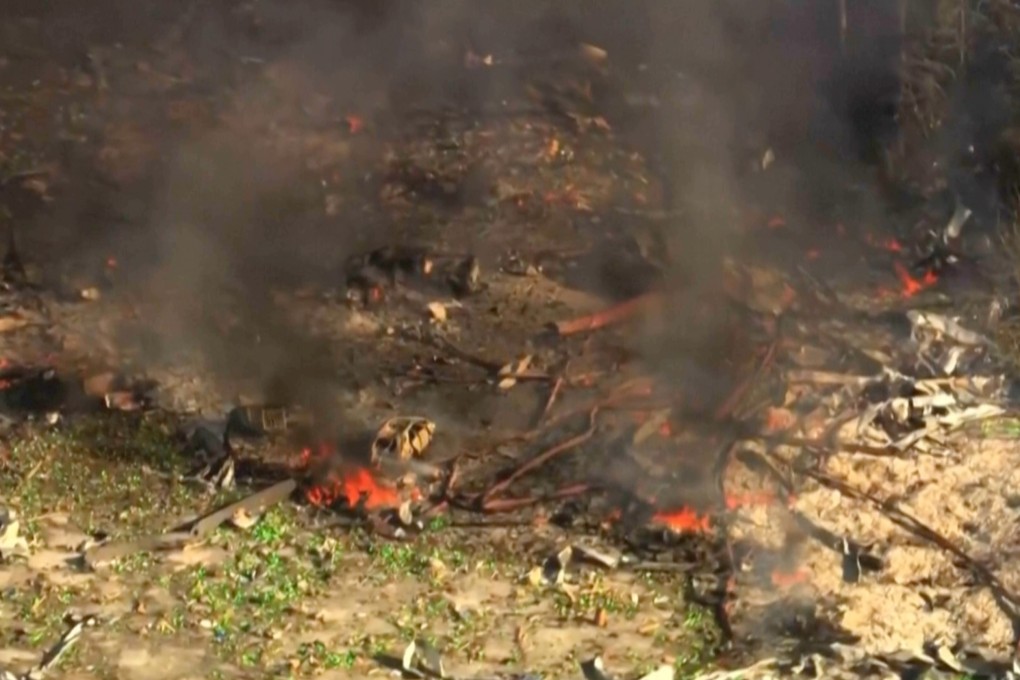 Smoke fills the air as debris covers the ground after a powerful blast ripped through a military explosives manufacturing plant in Hickman County, Tennessee, on Friday. Photo: WTVF-TV via AP