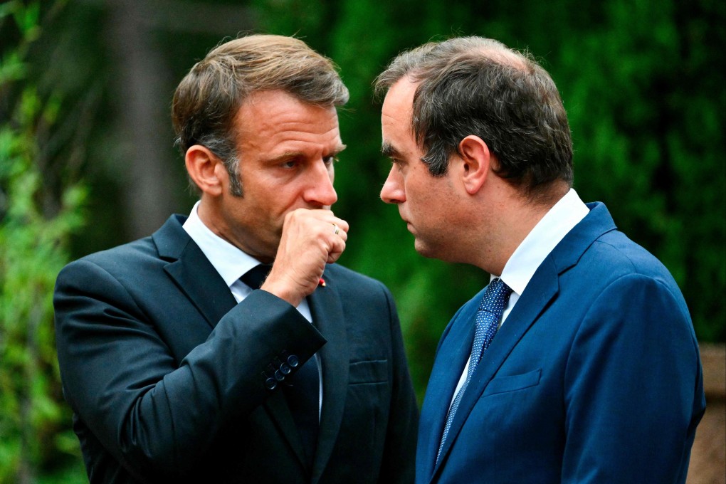 France’s President Emmanuel Macron speaks with centrist ally Sebastien Lecornu in Boulouris-sur-Mer, France, in August 2024. Photo: AFP