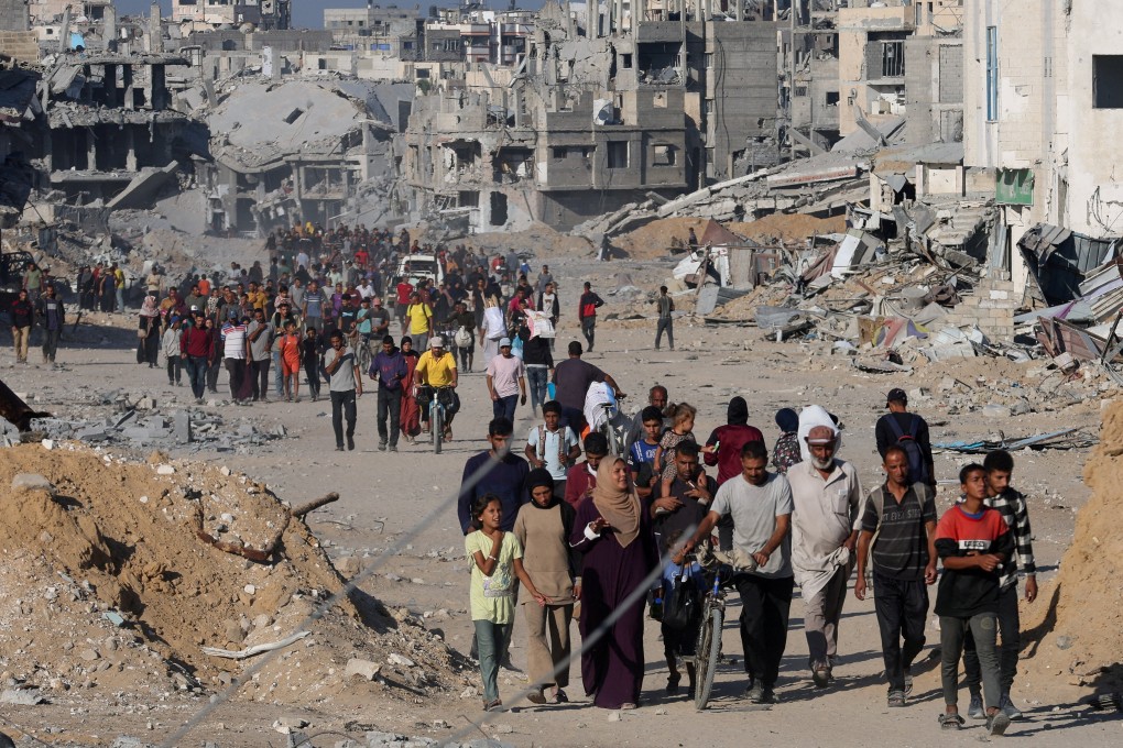 Palestinians walk past rubble as they return to their neighbourhood in Khan Younis, in southern Gaza Strip on Saturday, following Israeli forces’ withdrawal from the area, amid a ceasefire between Israel and Hamas in Gaza. Photo: Reuters